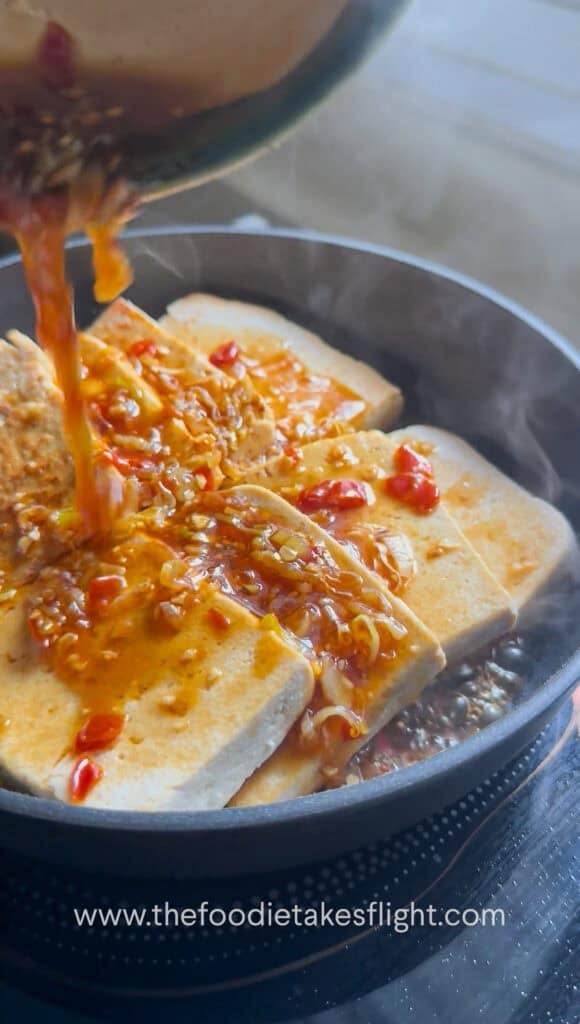 Golden pan-fried tofu simmering in sweet and spicy sauce