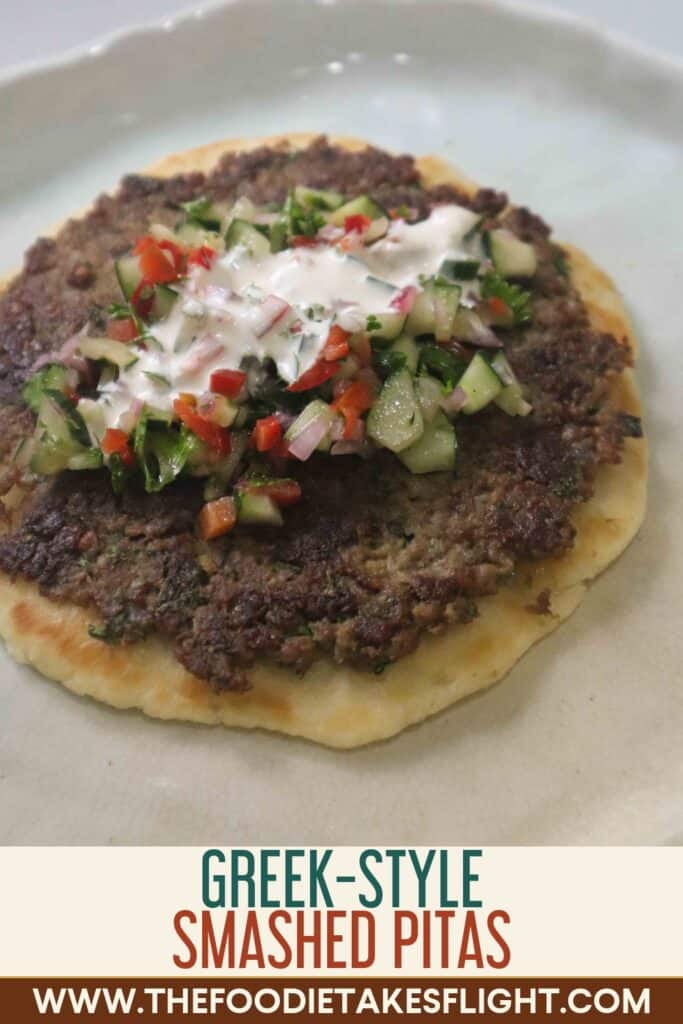 Greek-style smashed kebab pitas topped with chopped cucumber salad, parsley, and creamy yogurt dressing