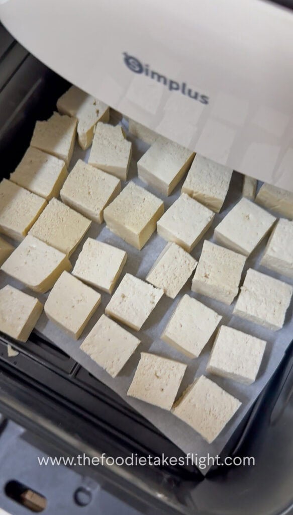 Tofu cubes laid out on an air fryer