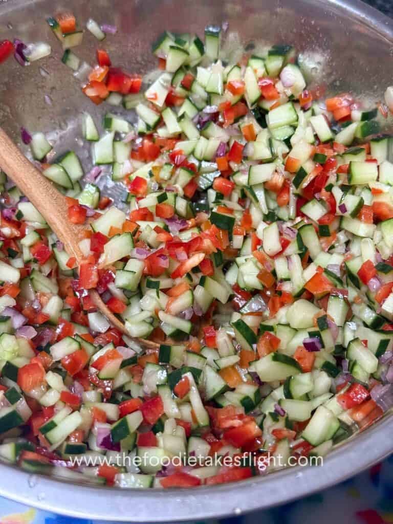 Chopped cucumber, red bell pepper, red onion, and parsley salad for pita wraps
