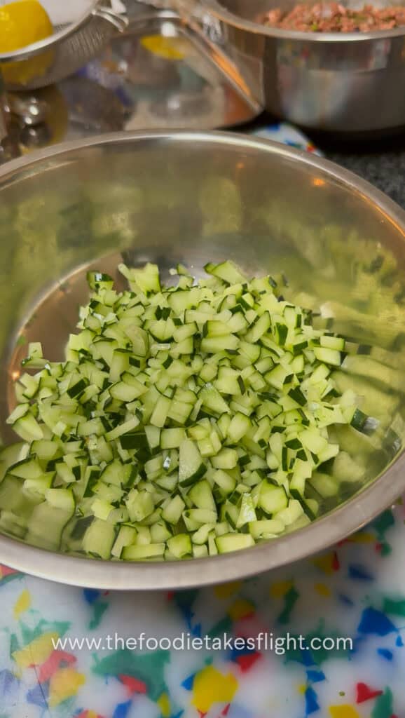 Chopped cucumber, red bell pepper, red onion, and parsley salad for pita wraps