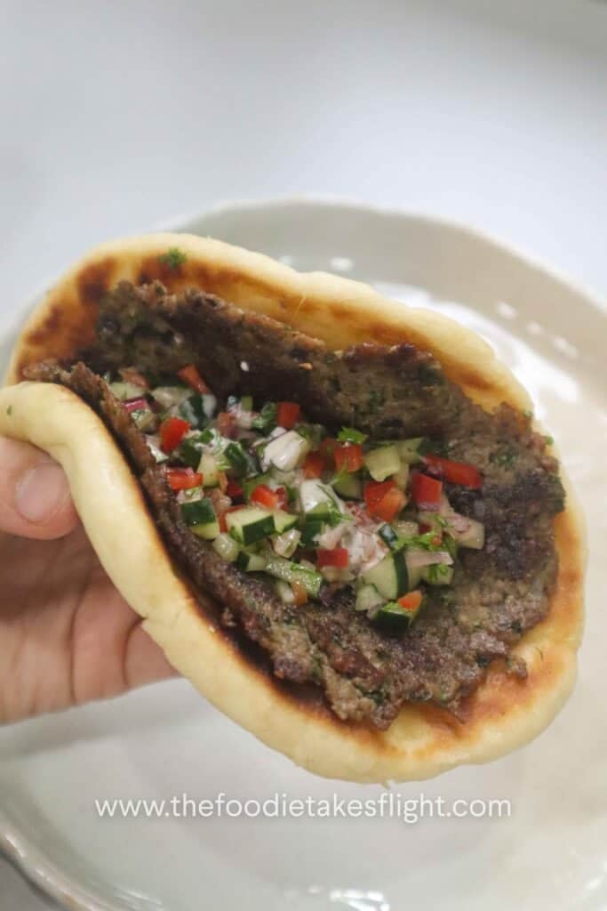 Folded smashed kebab pita wrap with crispy Impossible meat filling and fresh salad