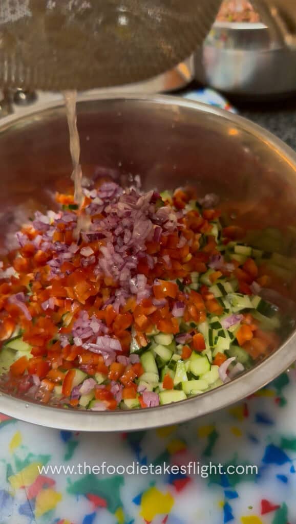 Chopped cucumber, red bell pepper, red onion, and parsley salad for pita wraps