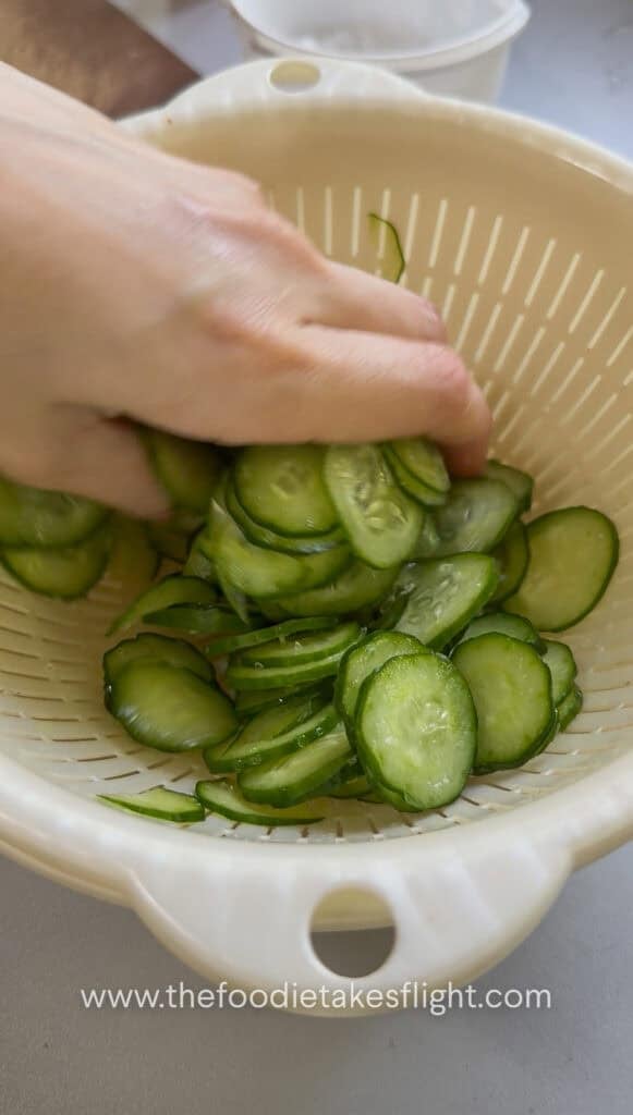 thinly sliced cucumber salted to release moisture