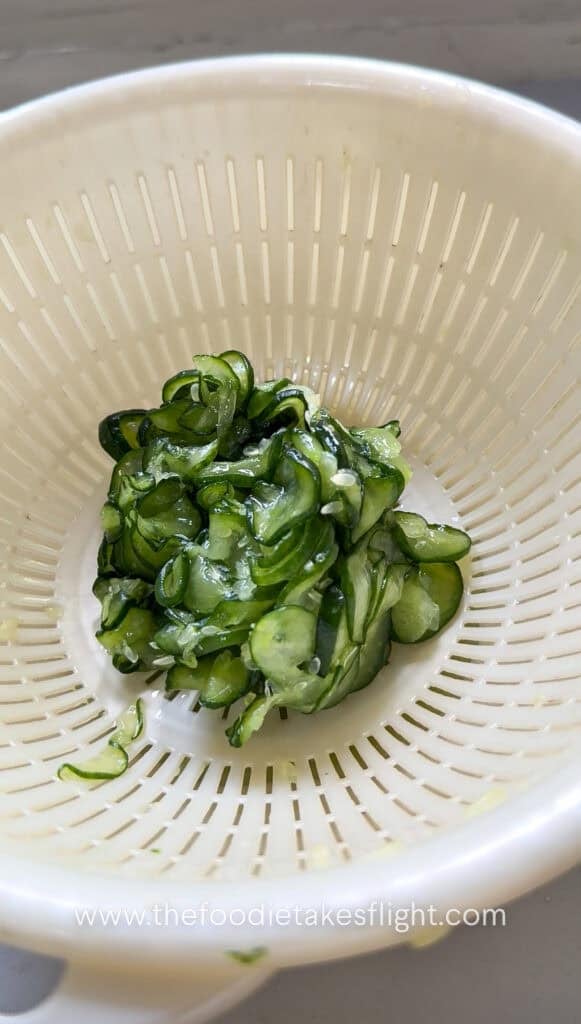 thinly sliced cucumber salted to release moisture