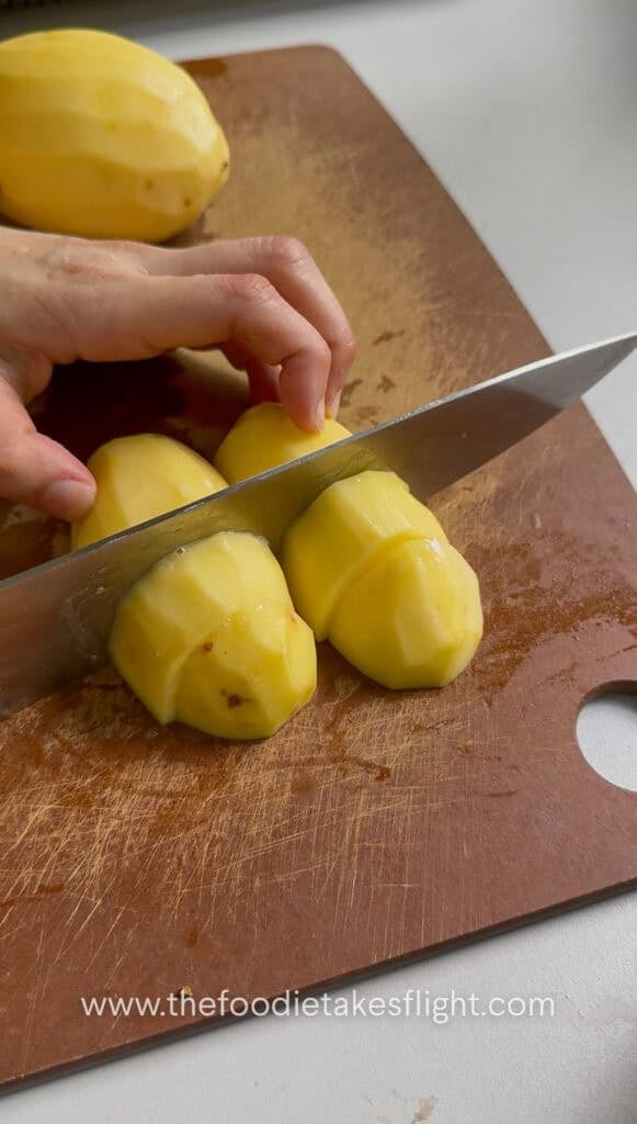 slicing whole peeled potatoes