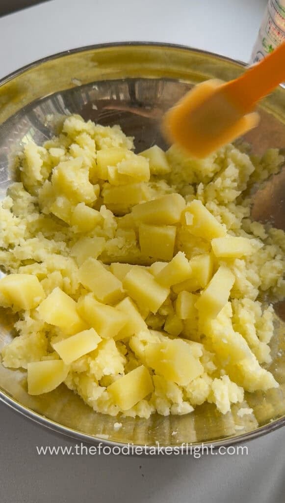 Cubed potato pieces folded into mashed potatoes for a chunky texture