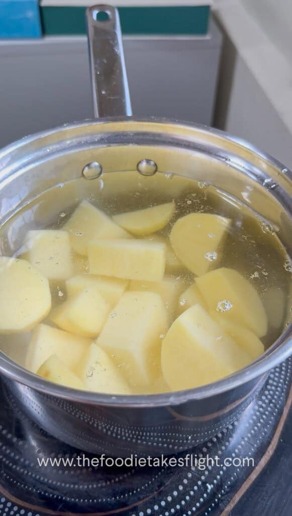 Potatoes added to a pot of cold salted water before boiling