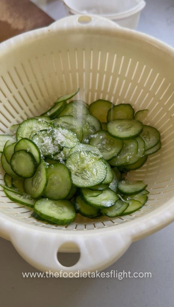 thinly sliced cucumber salted to release moisture