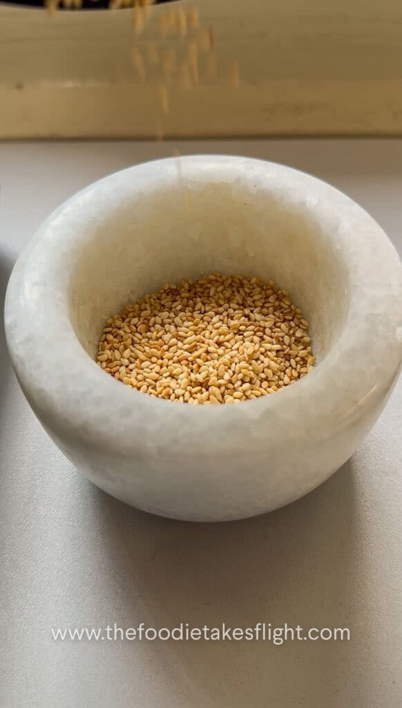Warm toasted sesame seeds in a mortar and pestle