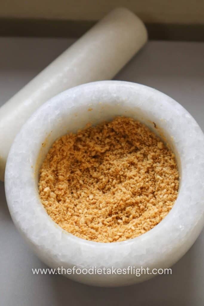 Crushed roasted sesame seeds with a coarse, nutty texture