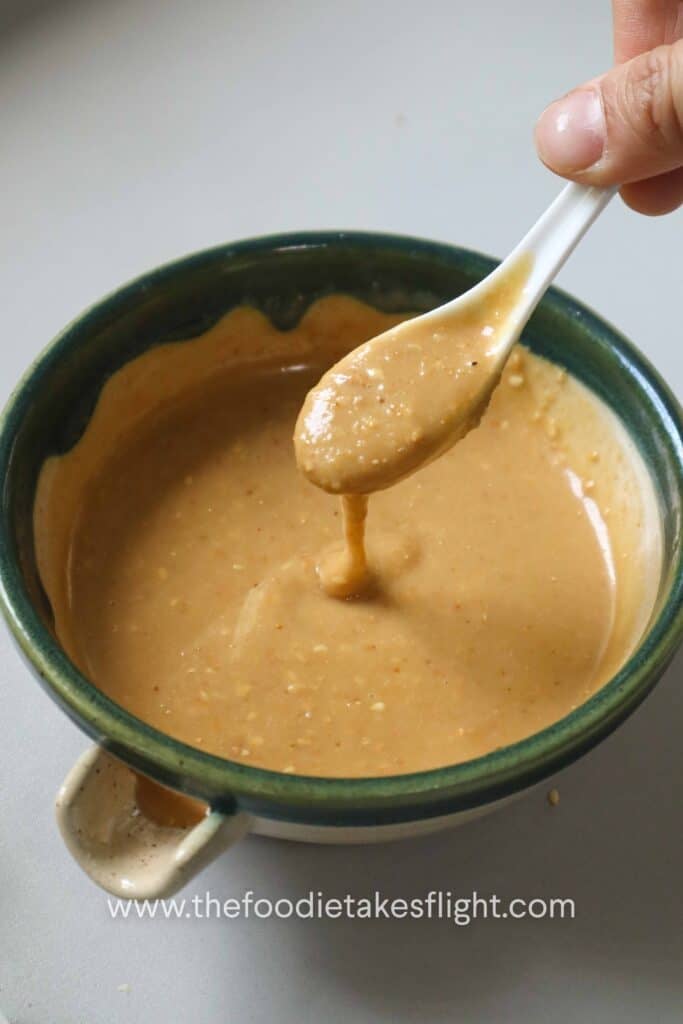 Spoonful of creamy roasted sesame dressing showing its texture