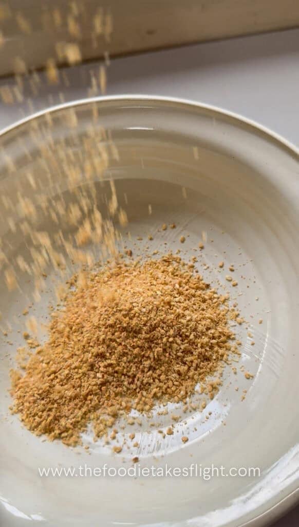 Crushed roasted sesame seeds with a coarse, nutty texture