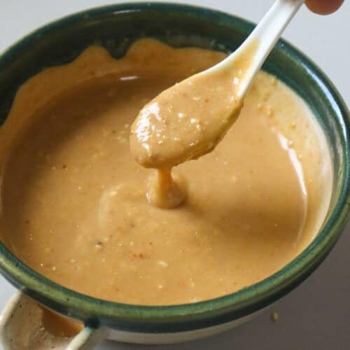 Spoonful of creamy roasted sesame dressing showing its texture