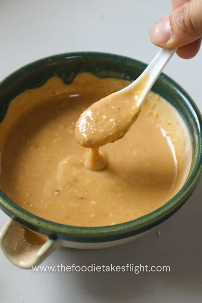 Spoonful of creamy roasted sesame dressing showing its texture