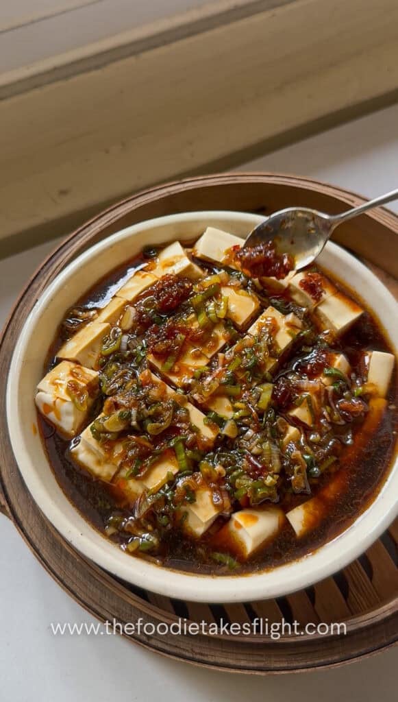 Chili oil being put over tofu