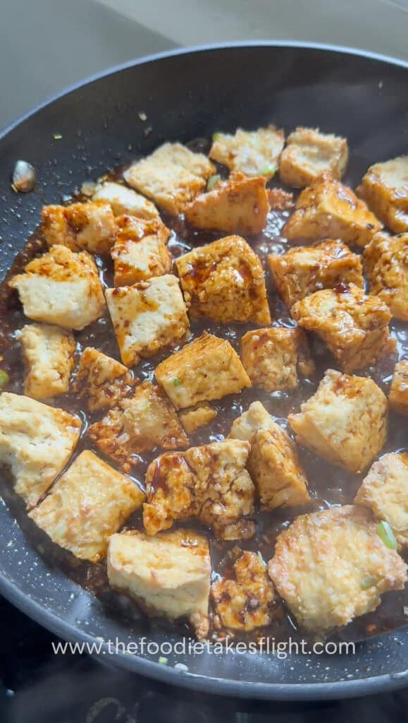 Sticky hoisin sauce poured over the crispy tofu pieces