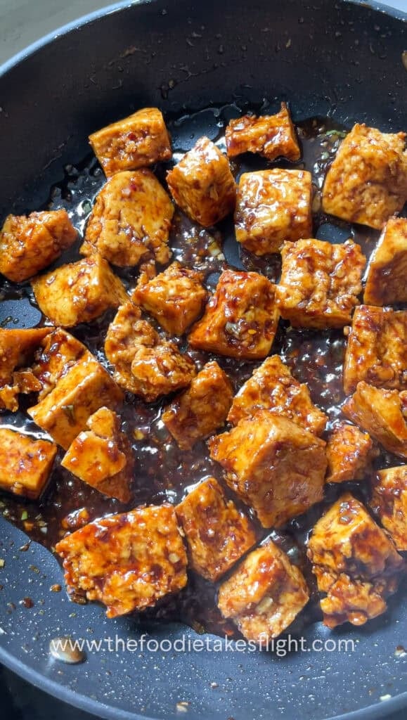 a pan full of crispy hand-torn tofu in glossy hoisin sauce