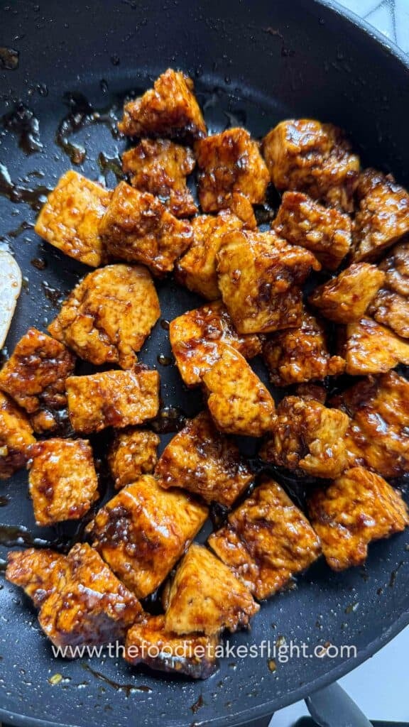 a pan full of crispy hand-torn tofu in glossy hoisin sauce