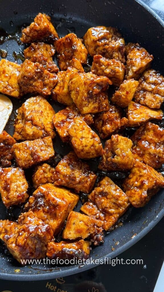 a pan full of crispy hand-torn tofu in glossy hoisin sauce