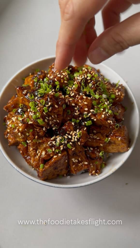 sticky tofu rice bowl recipe with crispy hand-torn tofu in glossy hoisin sauce over steamed rice