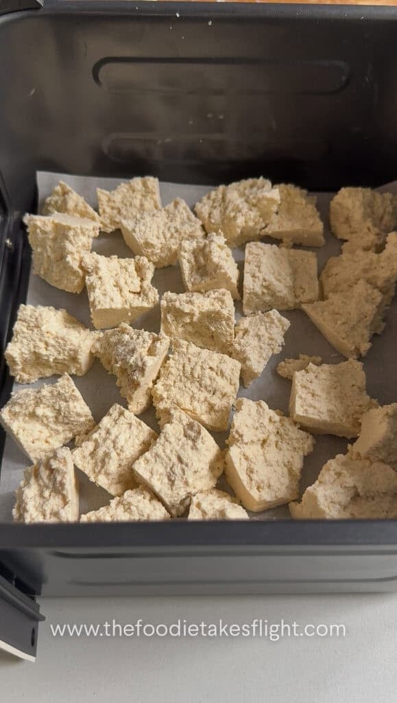 broken apart extra firm tofu in an air fryer