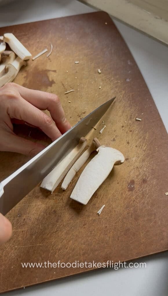 Baby king oyster mushrooms sliced into small strips or batons