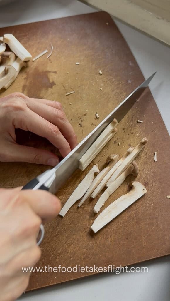 Baby king oyster mushrooms sliced into small strips or batons