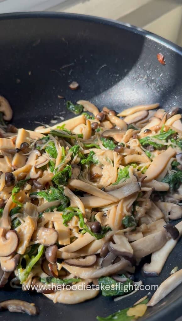 Warm mushroom salad tossed until the spinach wilts and the dressing coats the mushrooms