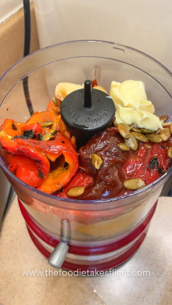Roasted red peppers, roasted garlic, pumpkin seeds, gochujang, mayo, lemon juice, maple syrup, and olive oil added to a food processor